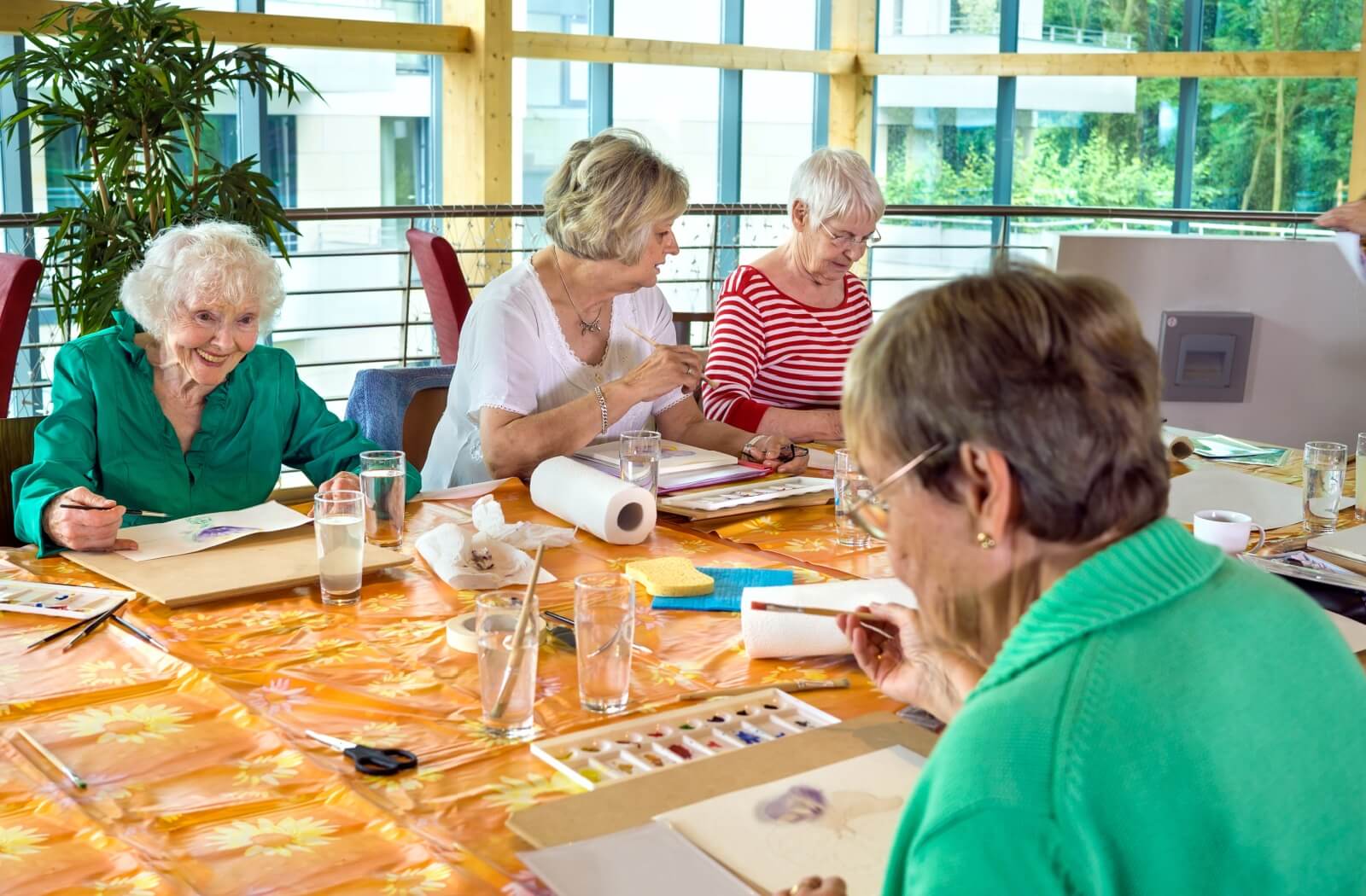 group of senior doing a painting class as a group activity in senior living