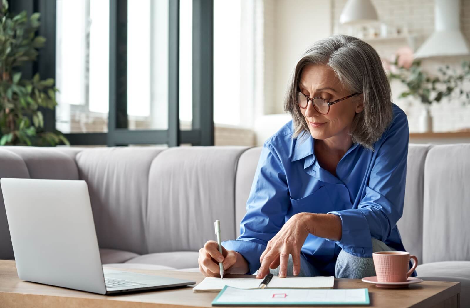 A senior takes notes on the qualifications needed for applying to an assisted living community near them